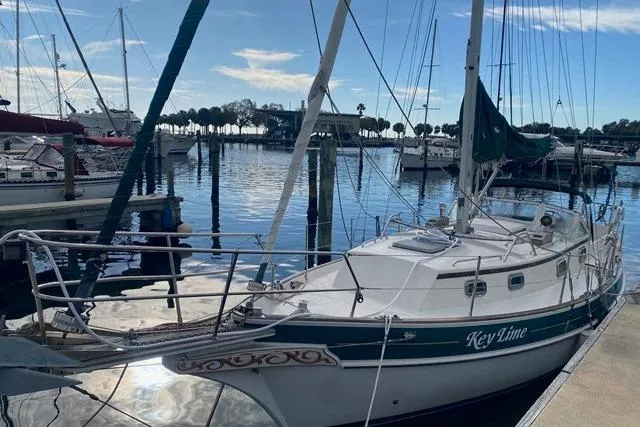 Slide: The Image of Sailboat "Key Lime" docked, Gozard 31 model, 1996, in a marina setting. - 1