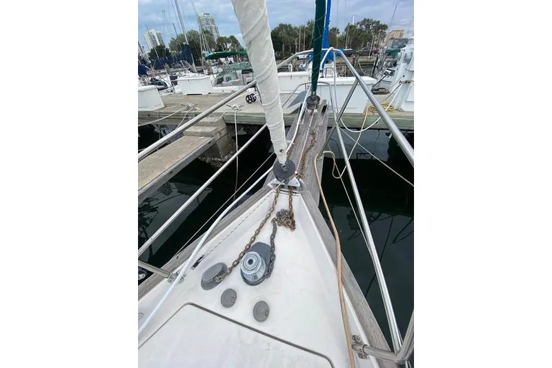 Slide: The Image of Sailboat deck view at marina, Gozard 31, 1996 model, with mooring lines and anchor chain. - 11