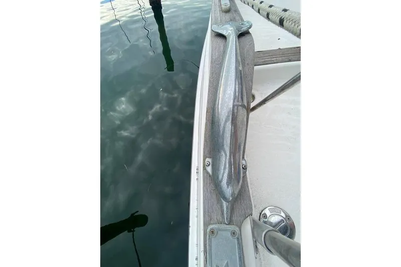 Slide: The Image of Close-up of a 1996 Gozard 31 boat deck with dolphin-shaped cleat. - 12