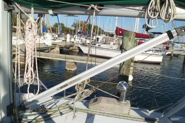 Slide: The Image of Sailboat rigging on a 1996 Gozard 31, docked at a marina with other boats. - 13