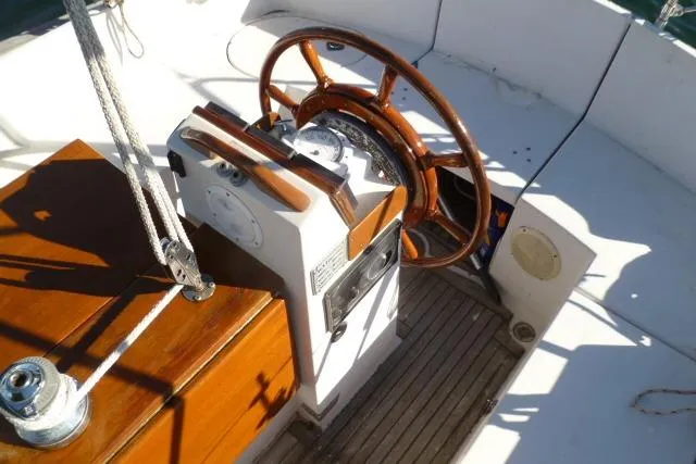 Slide: The Image of Steering wheel and controls of a 1996 Gozard 31 sailboat cockpit. - 17