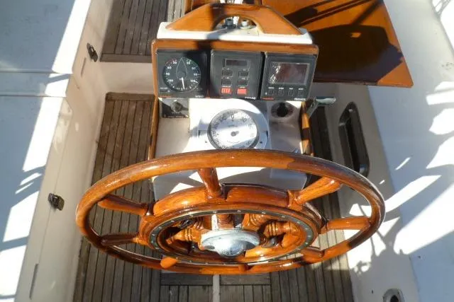 Slide: The Image of Wooden steering wheel and dashboard of a 1996 Gozard 31 boat. - 18
