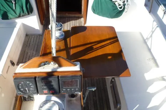 Slide: The Image of Cockpit of 1996 Gozard 31 sailboat with wooden table and navigation instruments. - 19
