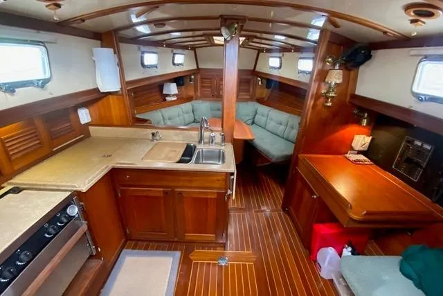 Slide: The Image of Interior of 1996 Gozard 31 sailboat with wood finish and cozy seating area. - 22
