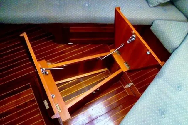 Slide: The Image of Hidden storage compartment in a 1996 Gozard 31 boat with wooden flooring. - 28