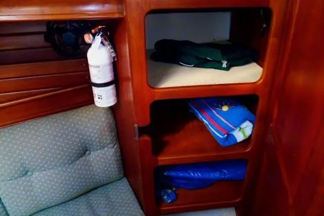 Slide: The Image of Interior of a 1996 Gozard 31 boat with shelves and a fire extinguisher. - 29