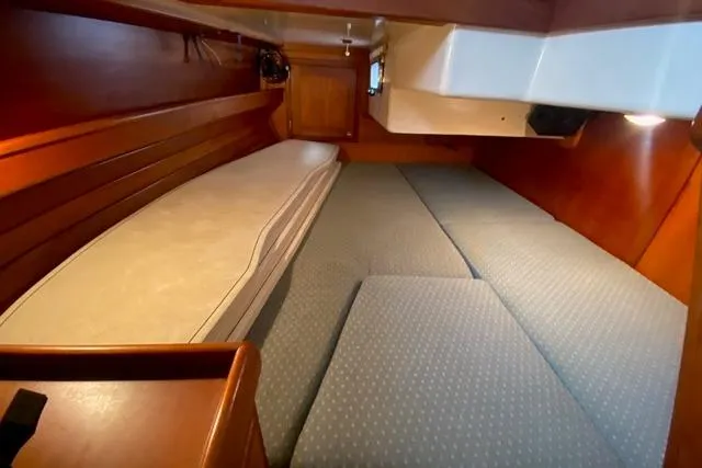 Slide: The Image of Cozy cabin interior of 1996 Gozard 31 sailboat with cushioned seating. - 33