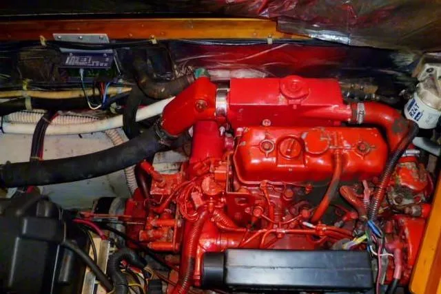 Slide: The Image of Red engine of a 1996 Gozard 31 boat, showcasing intricate wiring and components. - 39