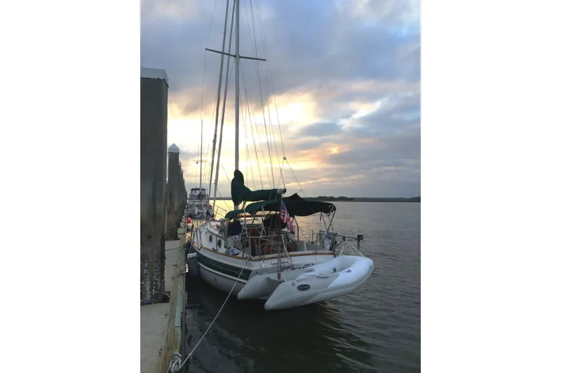 Slide: The Image of Sailboat docked at sunset, Gozard 31 model, 1996, with calm waters and cloudy sky. - 40