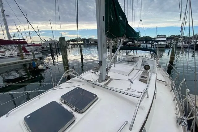 Slide: The Image of Sailboat docked at marina, Gozard 31 model, 1996, with overcast sky. - 7