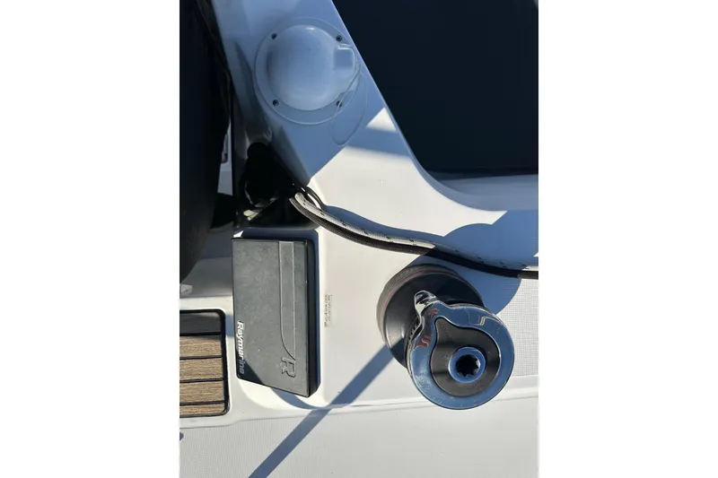 Slide: The Image of Close-up of Jeanneau Sun Odyssey 349 sailboat deck equipment, featuring a winch and Raymarine device. - 13