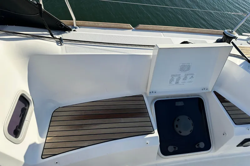 Slide: The Image of Cockpit storage area of 2021 Jeanneau Sun Odyssey 349 sailboat with open hatch. - 16