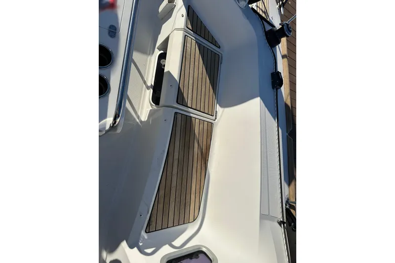 Slide: The Image of 2021 Jeanneau Sun Odyssey 349 deck with teak flooring and stainless steel railing. - 17