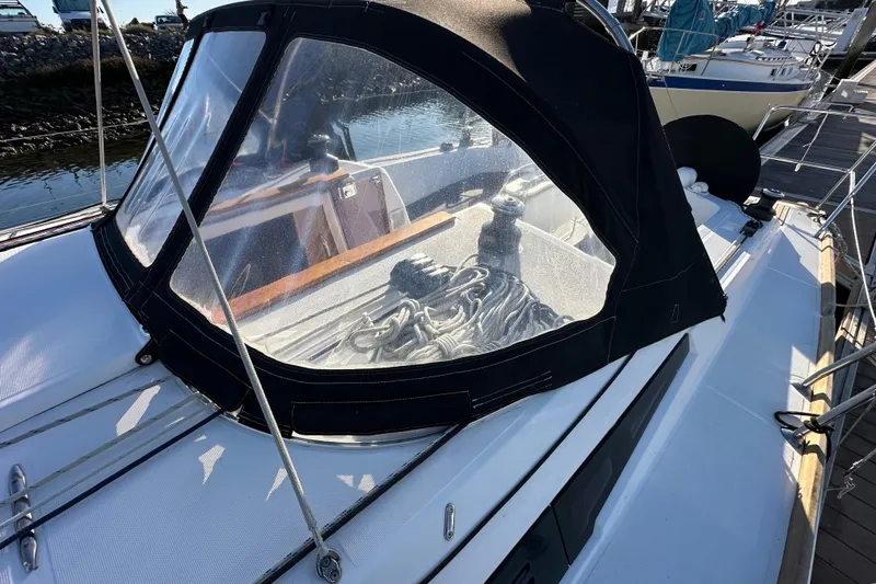 Slide: The Image of 2021 Jeanneau Sun Odyssey 349 sailboat with cockpit cover, docked at marina. - 19