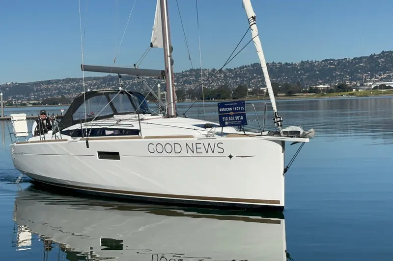 Slide: The Image of 2021 Jeanneau Sun Odyssey 349 sailboat named "Good News" on calm water. - 2