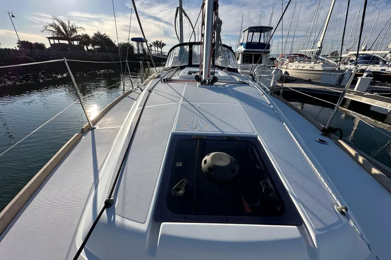 Slide: The Image of 2021 Jeanneau Sun Odyssey 349 sailboat docked at marina, sunny day, calm waters. - 24