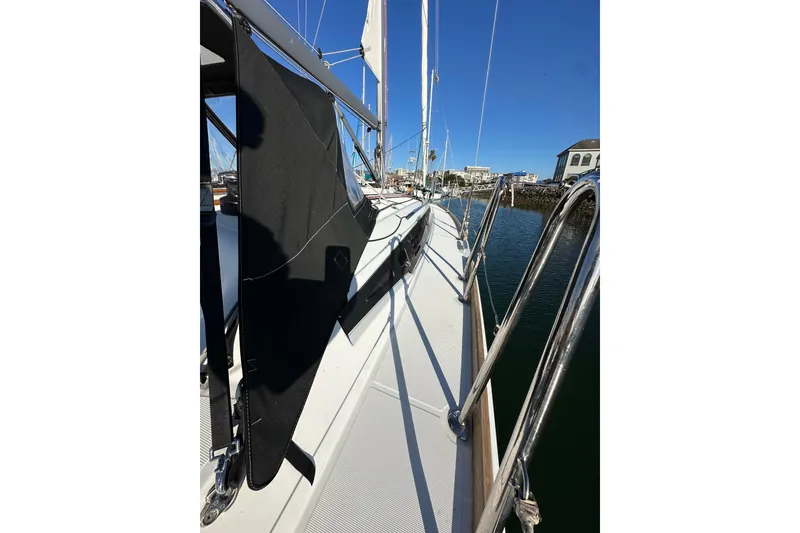 Slide: The Image of 2021 Jeanneau Sun Odyssey 349 sailboat docked, showcasing sleek deck and railing design. - 29