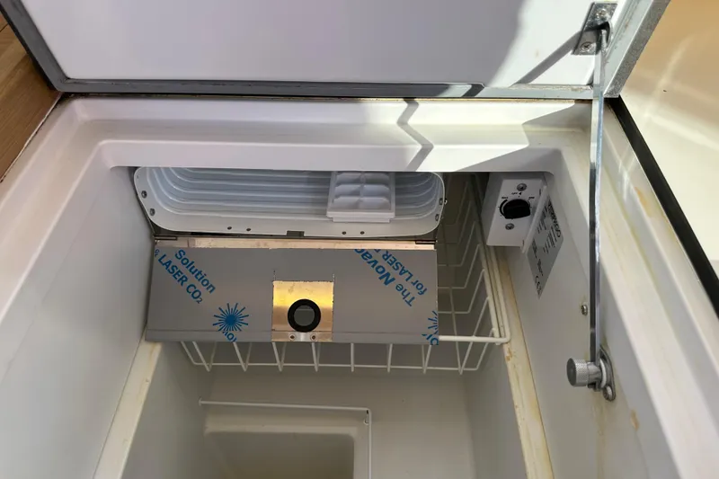Slide: The Image of Interior view of a 2021 Jeanneau Sun Odyssey 349 yacht refrigerator compartment. - 37