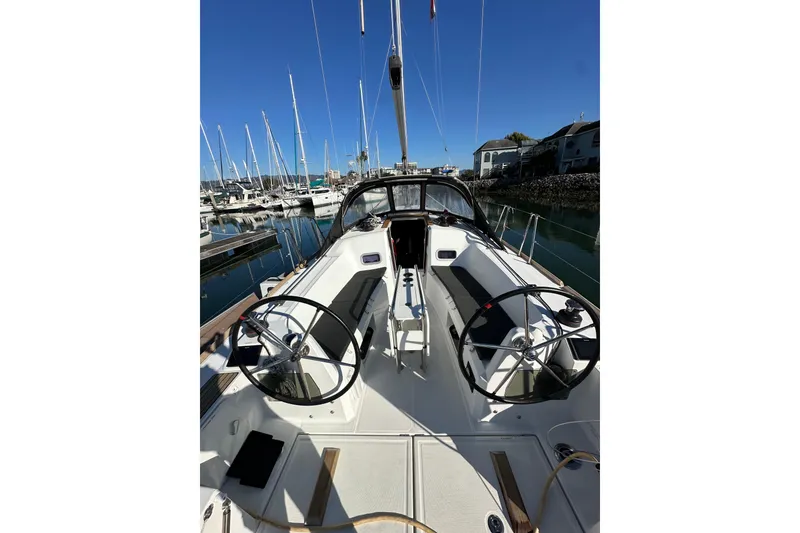 Slide: The Image of Jeanneau Sun Odyssey 349 sailboat, 2021 model, docked in a marina under clear blue skies. - 4