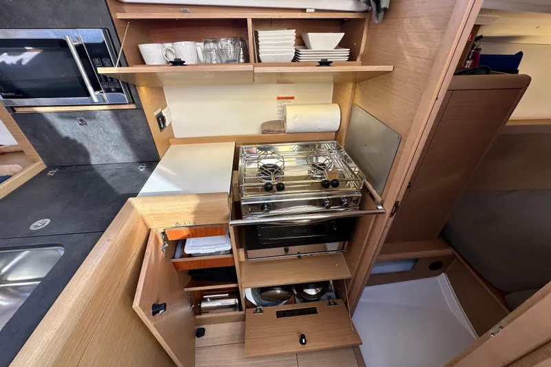 Slide: The Image of Modern kitchen in 2021 Jeanneau Sun Odyssey 349 yacht with stove and storage. - 40