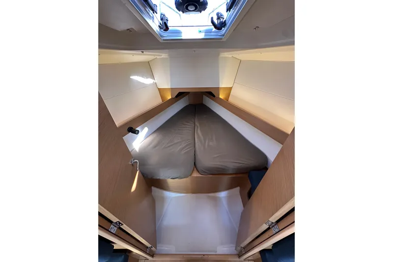 Slide: The Image of Interior cabin of 2021 Jeanneau Sun Odyssey 349 sailboat, featuring a cozy sleeping area. - 45