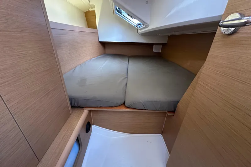 Slide: The Image of Cozy cabin interior of 2021 Jeanneau Sun Odyssey 349 sailboat with cushioned bed. - 55