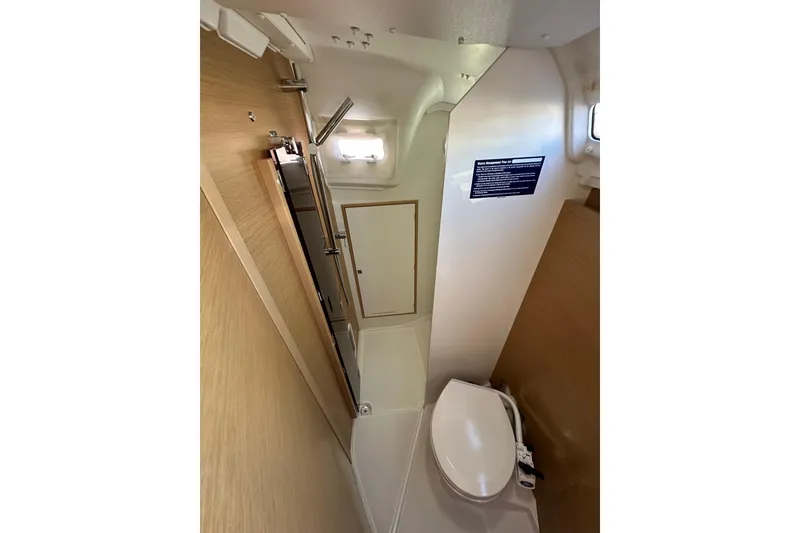 Slide: The Image of 2021 Jeanneau Sun Odyssey 349 yacht bathroom interior with modern fixtures and compact design. - 59