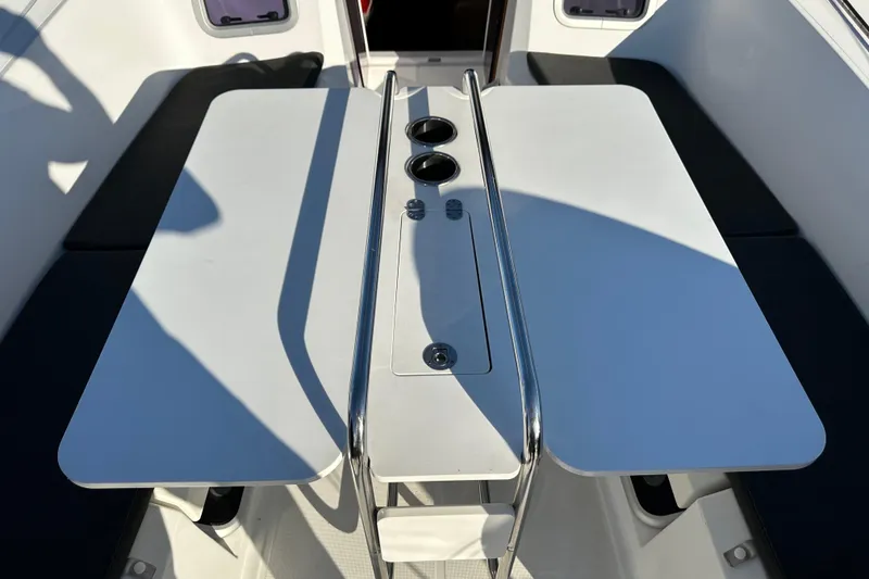 Slide: The Image of Cockpit table on 2021 Jeanneau Sun Odyssey 349 sailboat, featuring dual cup holders. - 7