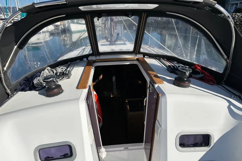 Slide: The Image of 2021 Jeanneau Sun Odyssey 349 cockpit with open hatch and winches. - 8