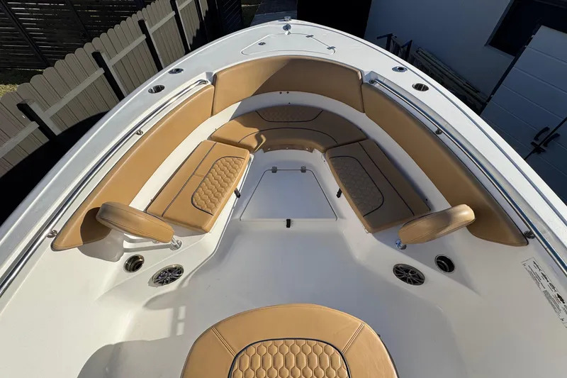 Slide: The Image of 2014 Sportsman Heritage 231 Center Console boat with tan seating and white deck. - 11