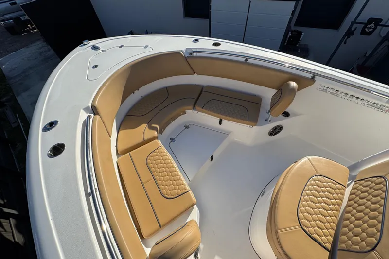 Slide: The Image of 2014 Sportsman Heritage 231 Center Console boat with tan cushioned seating. - 12