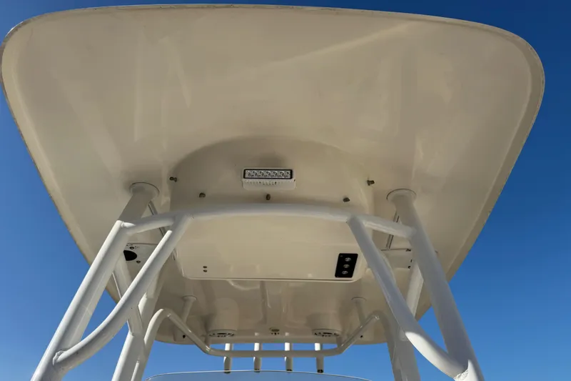 Slide: The Image of 2014 Sportsman Heritage 231 Center Console T-top against clear blue sky. - 17