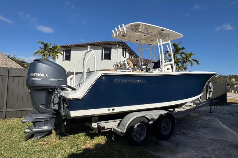 Slide: The Image of 2014 Sportsman Heritage 231 Center Console boat on trailer with Yamaha engine. - 2