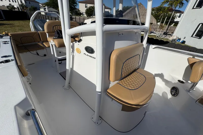 Slide: The Image of 2014 Sportsman Heritage 231 Center Console boat interior with tan seating and console. - 20