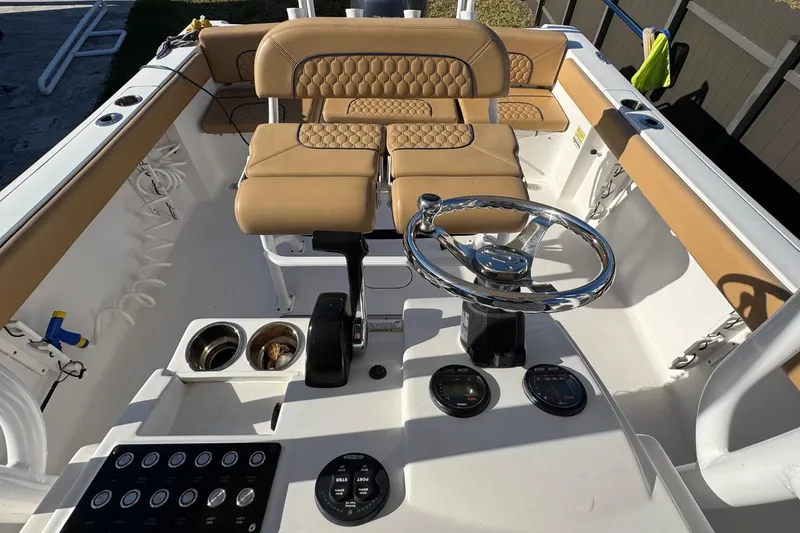 Slide: The Image of 2014 Sportsman Heritage 231 Center Console interior with tan seating and steering wheel. - 21