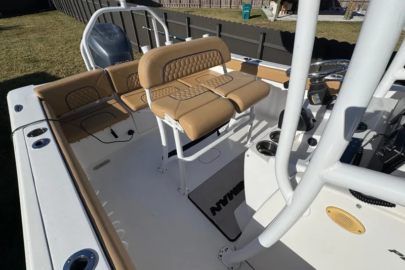 Slide: The Image of 2014 Sportsman Heritage 231 Center Console boat interior with tan seating and console. - 23