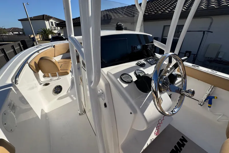Slide: The Image of 2014 Sportsman Heritage 231 Center Console boat interior with steering wheel and seating. - 25