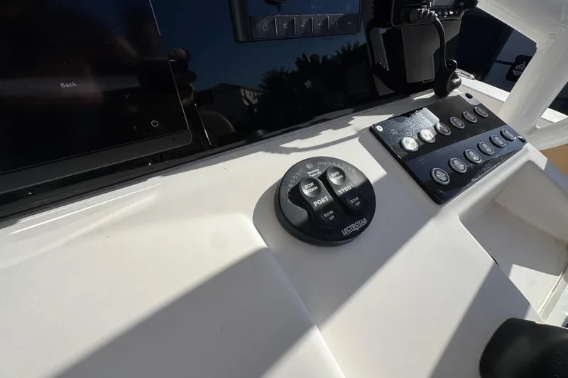 Slide: The Image of Control panel of 2014 Sportsman Heritage 231 Center Console boat with buttons and switches. - 29