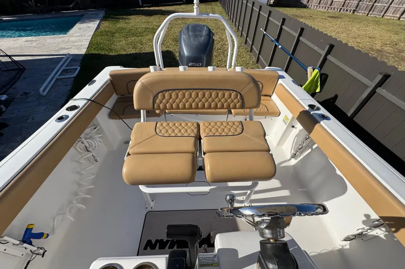 Slide: The Image of 2014 Sportsman Heritage 231 Center Console boat interior with tan seating and steering wheel. - 30