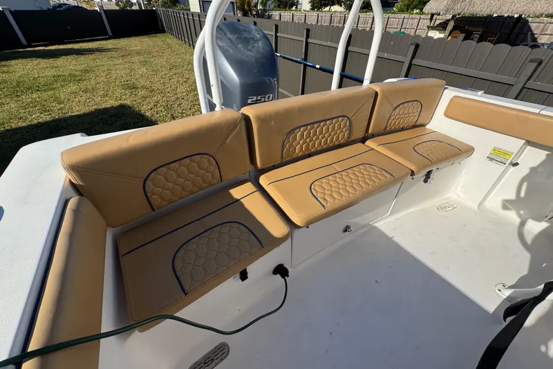 Slide: The Image of 2014 Sportsman Heritage 231 Center Console boat with tan cushioned seating. - 32