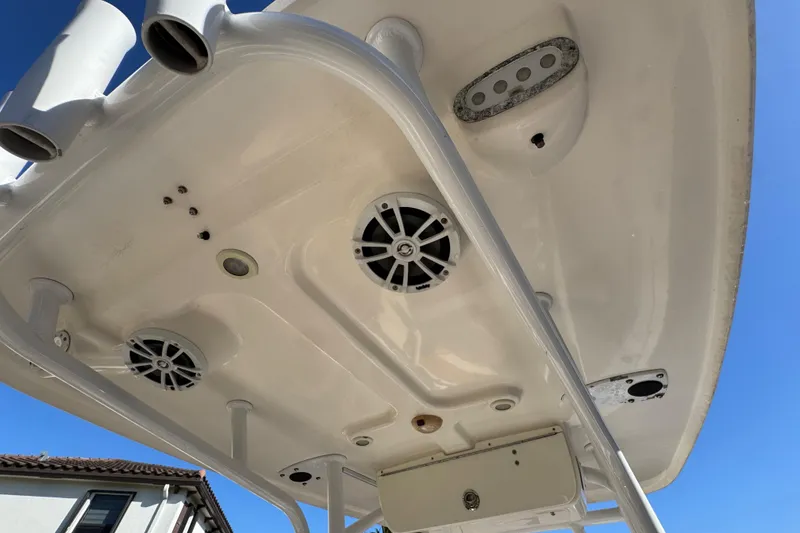Slide: The Image of 2014 Sportsman Heritage 231 Center Console boat speakers and rod holders, viewed from below. - 33