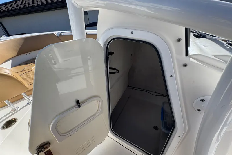 Slide: The Image of 2014 Sportsman Heritage 231 Center Console boat with open storage compartment. - 34