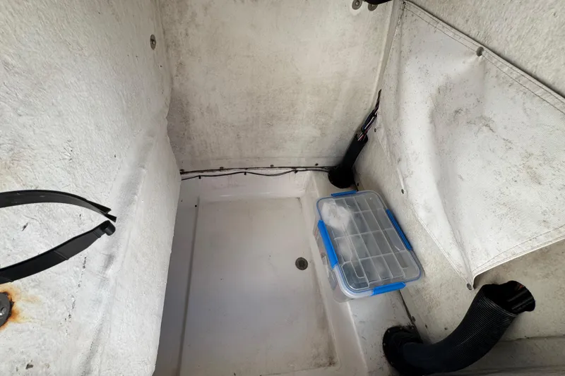 Slide: The Image of Interior of a 2014 Sportsman Heritage 231 Center Console boat with storage compartment. - 35