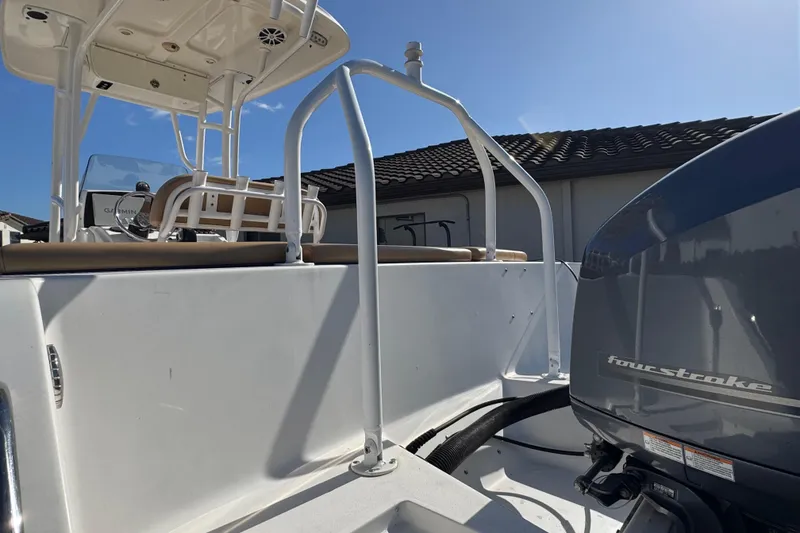 Slide: The Image of 2014 Sportsman Heritage 231 Center Console boat with four-stroke engine, viewed from the rear. - 37