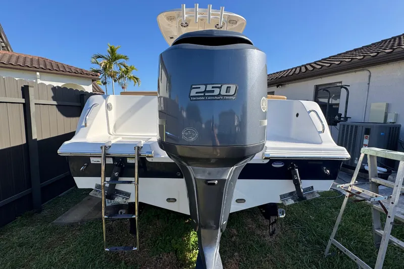 Slide: The Image of 2014 Sportsman Heritage 231 Center Console boat with Yamaha 250 engine in backyard setting. - 6
