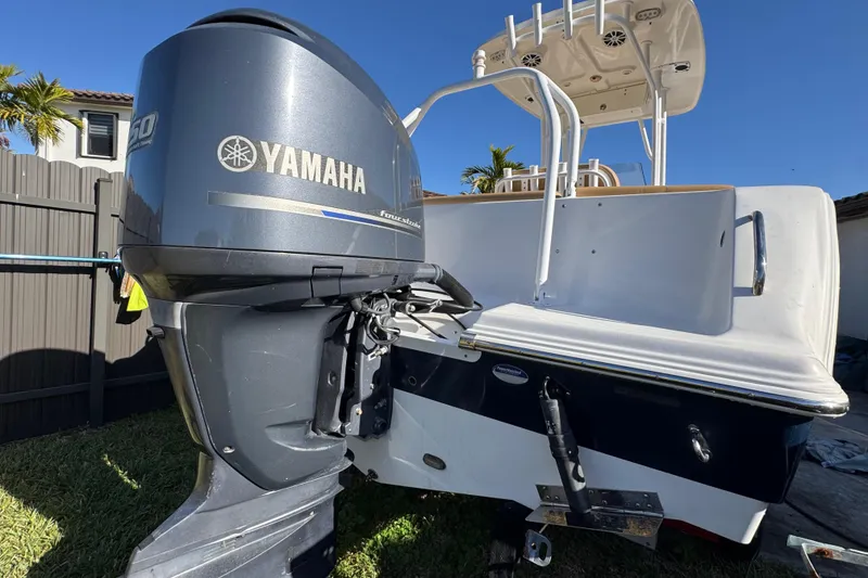 Slide: The Image of 2014 Sportsman Heritage 231 Center Console with Yamaha outboard motor in a backyard setting. - 8
