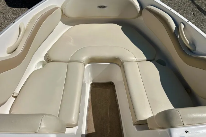 Slide: The Image of 2003 Chaparral 183 SS boat interior with beige cushioned seating. - 12