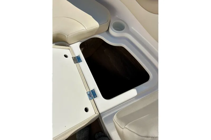 Slide: The Image of Open storage compartment in 2003 Chaparral 183 SS boat with beige seating. - 17