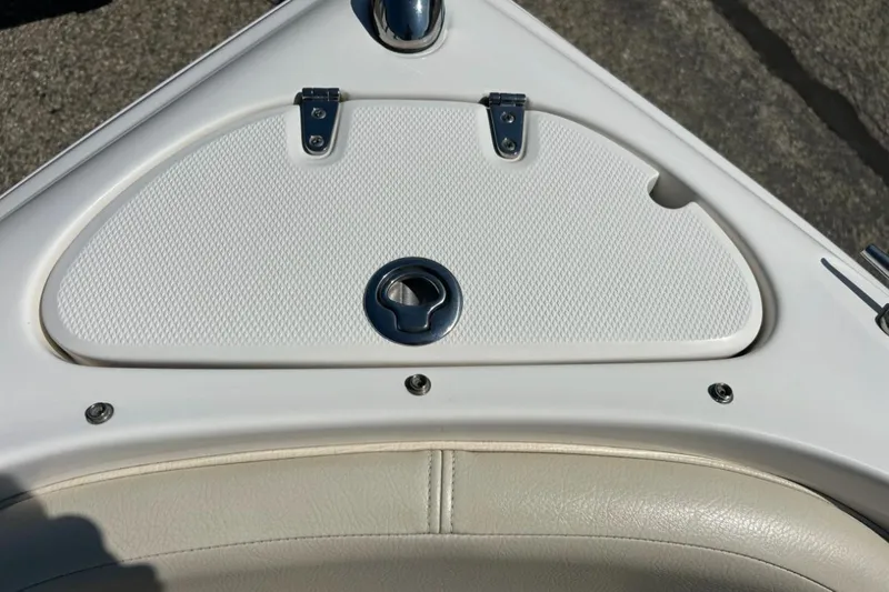 Slide: The Image of 2003 Chaparral 183 SS boat storage compartment with textured white cover and latch. - 20