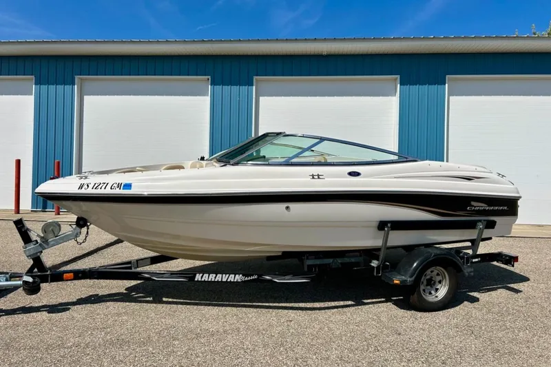 Slide: The Image of 2003 Chaparral 183 SS boat on trailer, parked outside blue building. - 3